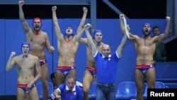 Serbia's bench celebrates a goal against Australia during their quarterfinal water-polo match.