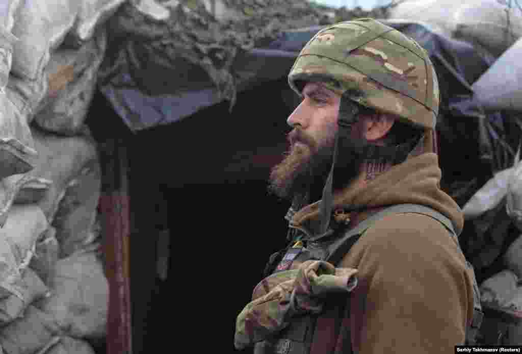 A Ukrainian soldier stands guard near Donetsk. Kremlin spokesman Dmitry Peskov says there is nothing to fear and that the repositioning of military forces within Russia's borders is a strictly domestic concern.