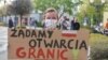 Протестующая на польско-германской границе с плакатом "Требуем открытия границ!"