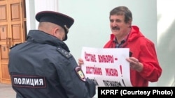Sergei Andrunevich (right) is a retired lieutenant colonel in Russia's Federal Security Service.