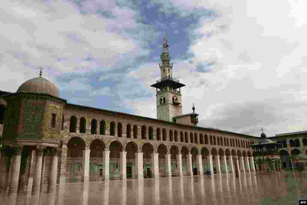 The courtyard of the Umayyad Mosque in old Damascus, 2010. The Umayyad Mosque, also known as the Grand Mosque of Damascus, was built on the Christian basilica dedicated to John the Baptist since the time of Roman Emperor Constantine I.