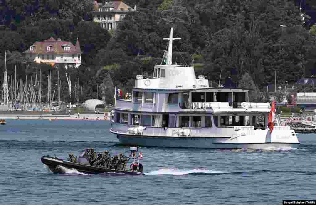 An inflatable boat filled with special forces patrols Lake Geneva on June 15. 
