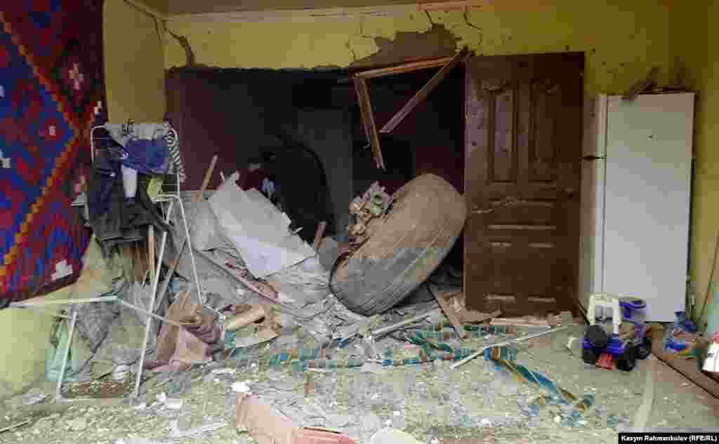 A section of the plane's landing gear inside a house. 