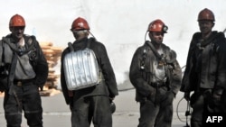 Russia -- Miners take iners rest after making a rescue attempt near the Raspadskayaking coal mine in Mezhdurechensk, 13May2010