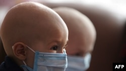 Children wear masks at a hospital for leukemia patients in the eastern Ukrainian city of Donetsk. The risk of leukemia in children in the contamination zones is three times higher than elsewhere.