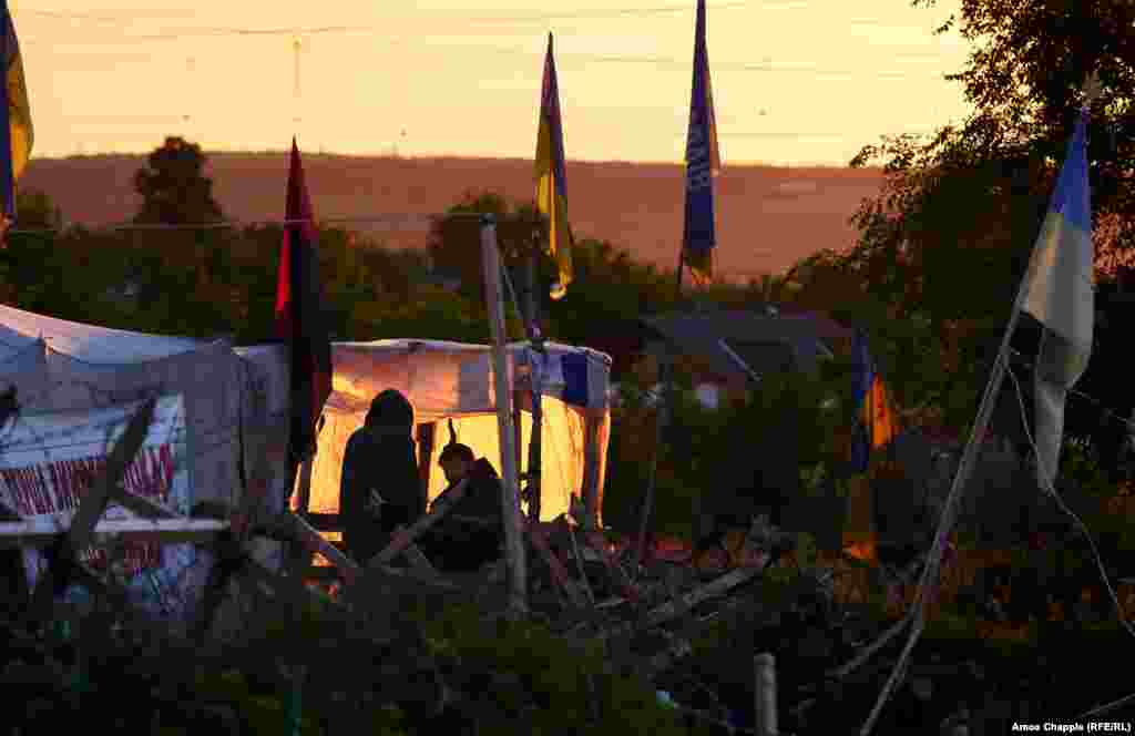 Guards at the entrance to the camp. After apparently forcing Kyiv’s hand in March, the activists now appear emboldened to demand more from a government they see as ineffectual. On May 26, the activists announced plans to begin a new stage of activity "within two weeks," targeting Russian-linked businesses in Ukraine.  