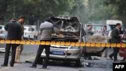Investigators work at the site where a vehicle exploded near the Israeli Embassy in New Delhi.