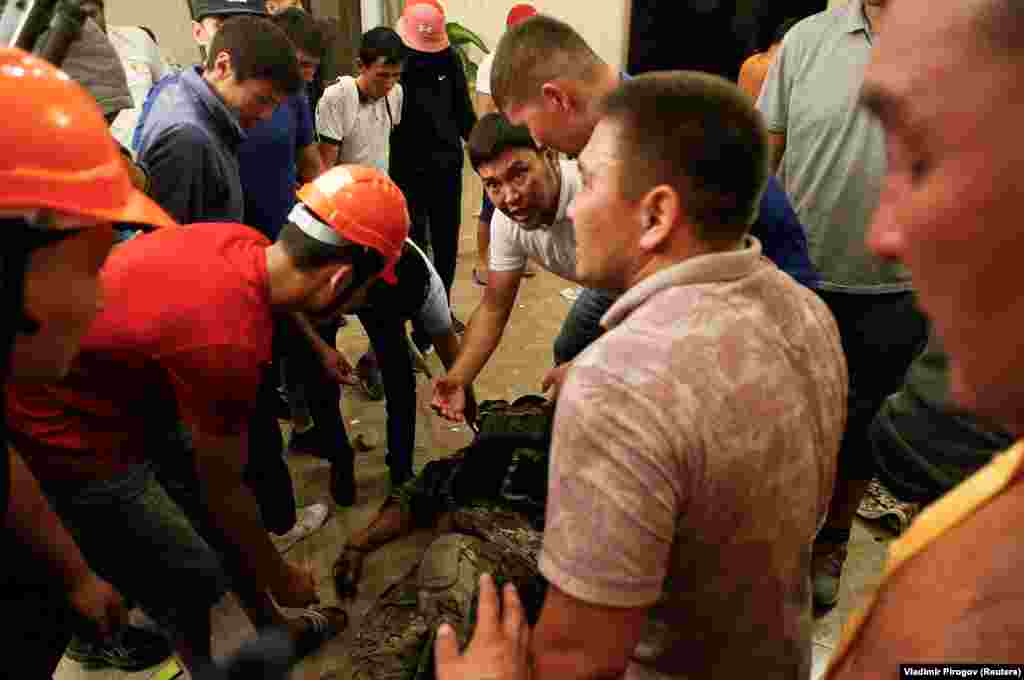 Supporters of Atambaev surround an apparently unconscious member of the special forces team. One policeman was shot dead in the operation. 