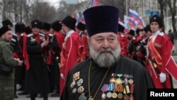 A Russian Orthodox priest attends a rally marking the second anniversary of Russia's annexation of Ukraine's Crimea region in the Black Sea port of Sevastopol on March 18.