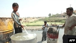 Iraqis fill their tanks with filthy water from the Diyala River east of Baghdad (file photo)