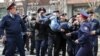 Kazakh police officers detain an anti-government protester during a rally in Almaty on March 22.