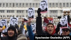 Demonstrators shouted slogans and held placards during the anti-corruption rally in Bishkek on November 25.