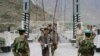 Tajik border guards check identification documents of people crossing the Tajik-Afghan border. (file photo)