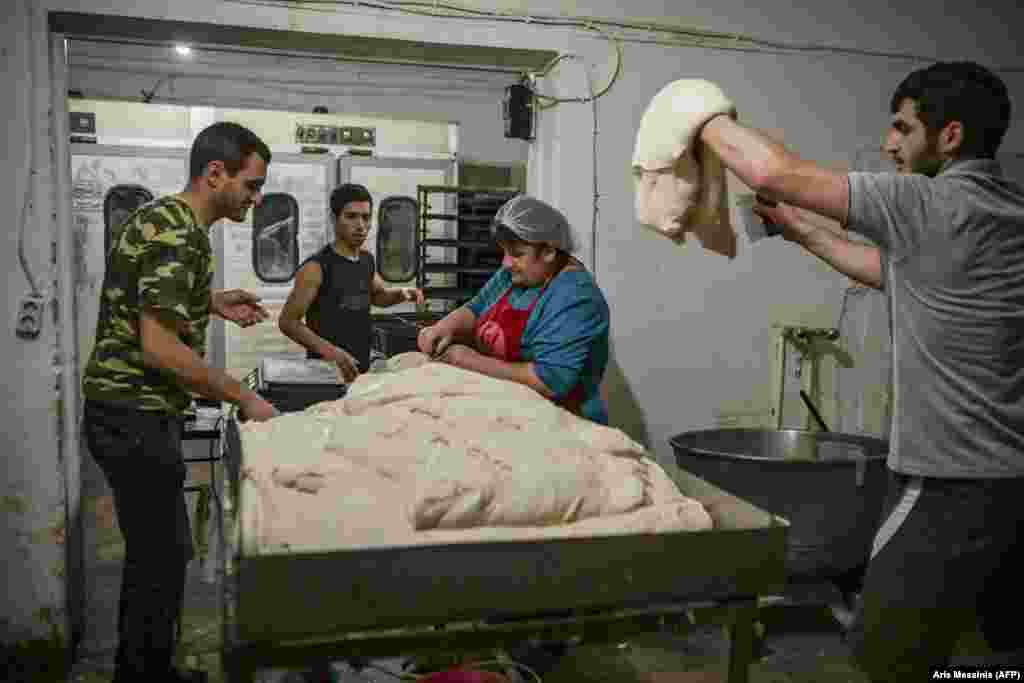 Workers at a bakery in Stepanakert prepare bread on October 21. The ethnic Armenian owners of the business are handing out their signature 700-gram loaves of bread for free to those who’ve remained in the city.      