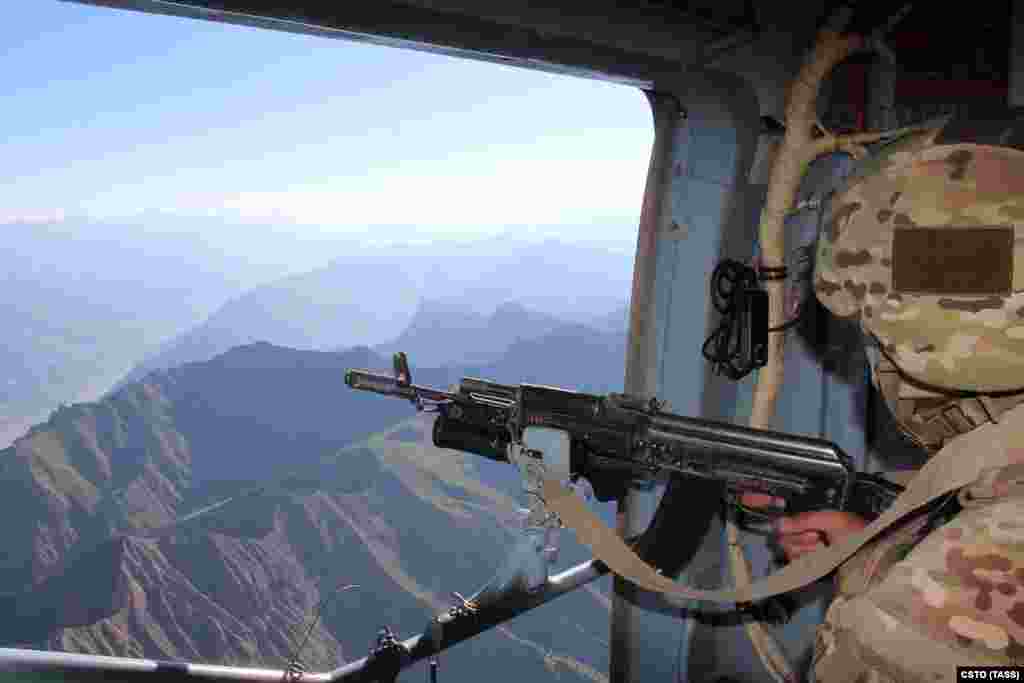 A serviceman from the Russian-led Collective Security Treaty Organization looks over the border area between Tajikistan and Afghanistan on July 5. Tajikistan has seen a surge of refugees fleeing across the border amid the recent Taliban advances. 