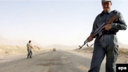 Afghan police guard the Kabul-Kandahar highway