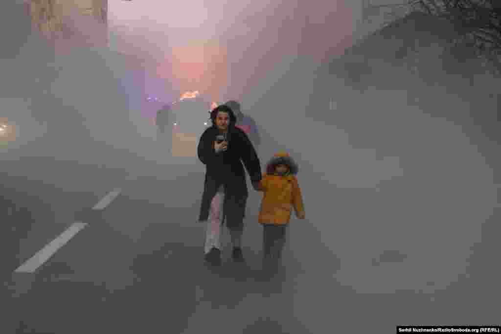 A child is led away from the impact site of a Russian strike on Kyiv on December 20, 2024. 