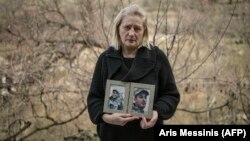 Lusine Margarian holds photographs of her son Hayk, 23, an Armenian soldier who went missing during last years war with Azerbaijan, in Yerevan on March 7.