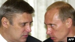 Then-Russia Prime Minister Mikhail Kasyanov speaks with President Vladimir Putin (right) in June 2003.