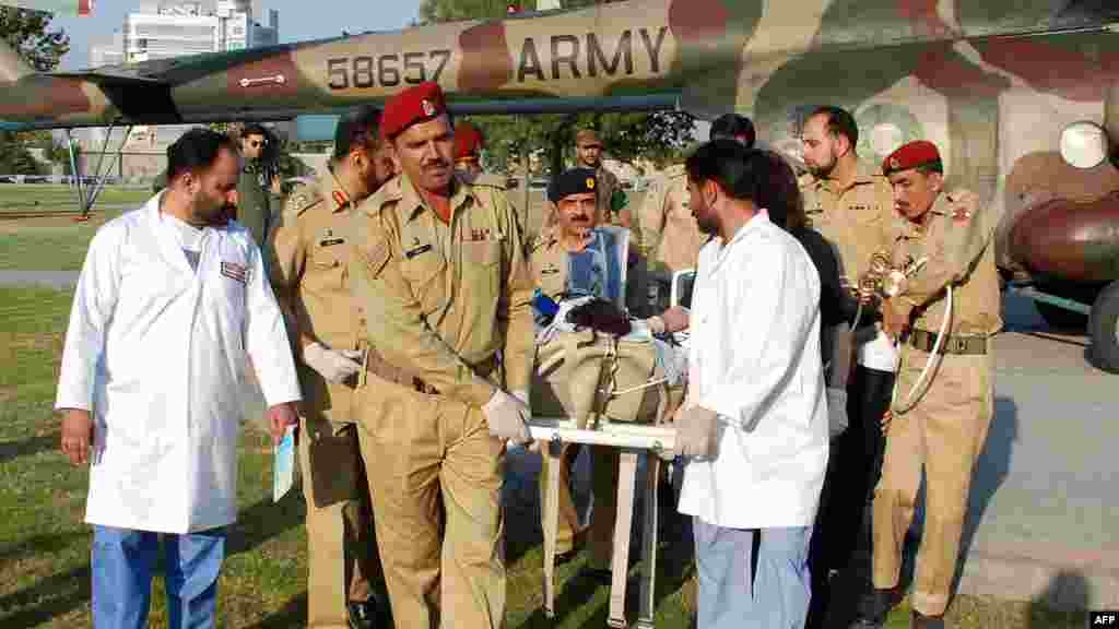 Malala is transported from a helicopter to an army hospital by doctors.