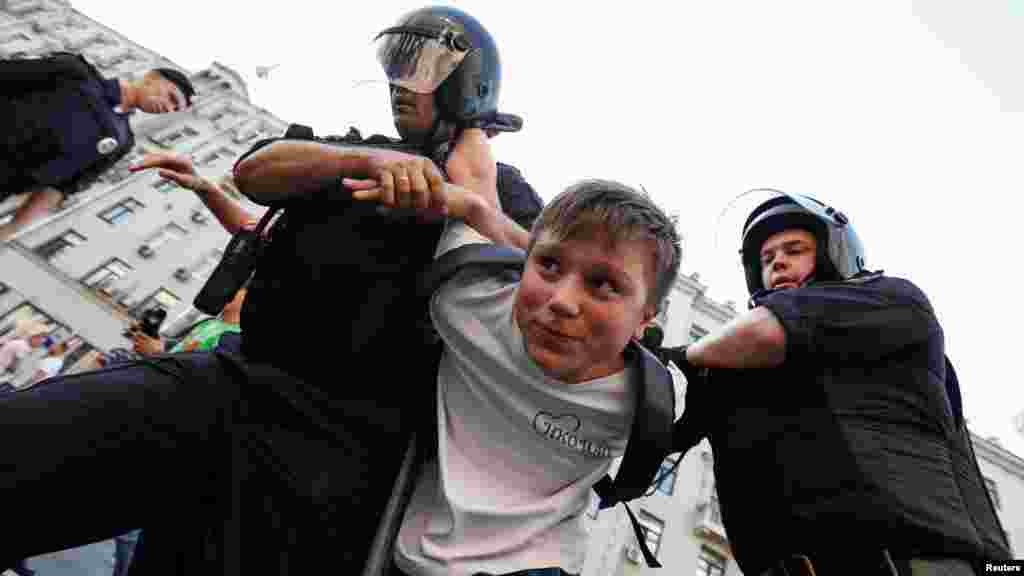 A youngster is detained in Moscow. According to a recent survey, some 90 percent of Russians oppose the plan to raise the retirement age, and a recent poll by the Levada Center polling agency found that more than 50 percent of Russians say they would participate in protests against it.