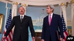 U.S. Secretary of State John Kerry (right) speaks with Azerbaijani President Ilham Aliyev in Washington on March 30.