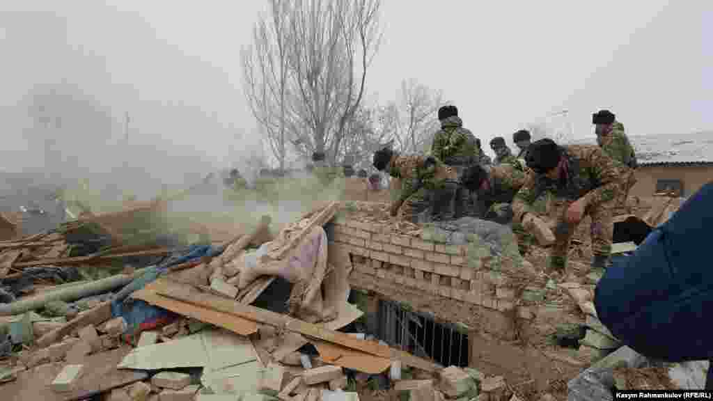 Damaged houses being searched. Around 20 homes are reported to have been destroyed in the crash. 