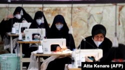 Iranian women make face masks and other protective items in the capital, Tehran, amid a coronavirus outbreak, which has killed thousands of people in the country.