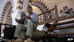 Crimean Tatars pray inside a mosque during the Eid al-Adha festival in Crimea. The annexed Ukrainian peninsula has been referenced in a new report on religious freedom that criticizes Russia's "repressive policies" toward people of certain faiths.