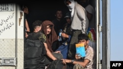 Afghan refugees arrive in the Islam Qala border crossing between Afghanistan and Iran on June 27, 2025, following their deportation from Iran.