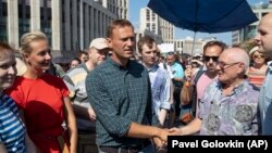 Russian opposition leader Aleksei Navalny (center) shakes hands with people during an opposition rally in Moscow last month against proposed pension reforms.