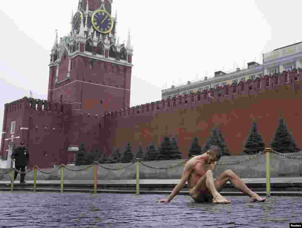 Pavlensky nails his scrotum to cobblestones on Moscow's Red Square to protest the "political indifference" of Russians in November 2013. 