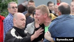 Though they wore no official uniforms, the plainclothes police bore the obvious hallmarks of the “undercover” thug: clean-shaven, muscular, buzz cuts, and scowls.