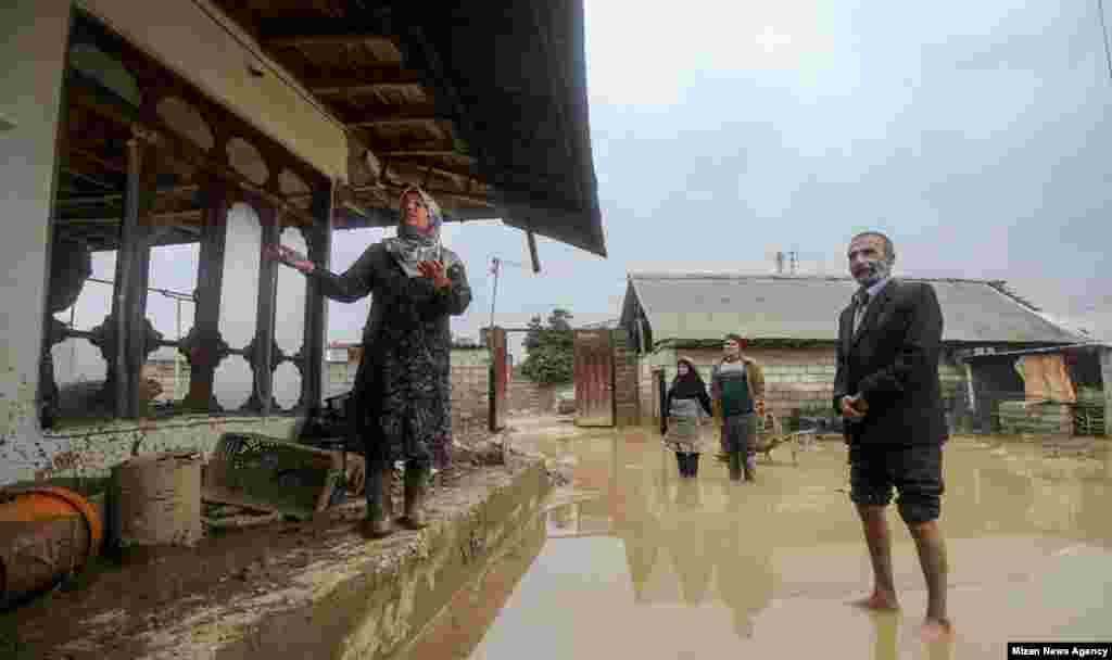 Residents of northern Iran show their flood-damaged home. 