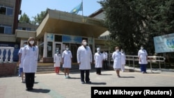 Kazakh medics gather outside a hospital in Almaty to observe a minute's silence for COVID-19 victims on July 13.