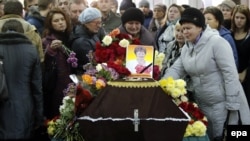 Mourners grieve at the coffin of Nina Lushchenko, a victim of the Russian MetroJet Airbus A321 crash in Egypt, during her funeral service at a church in Veliky Novgorod on November 5.