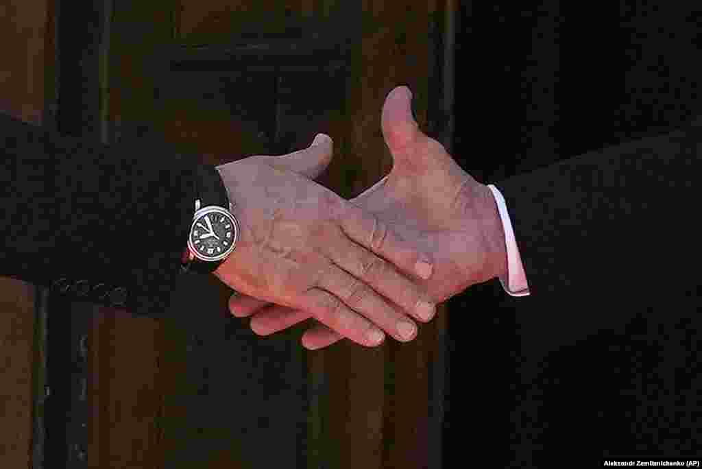 A close-up of a handshake between President Vladimir Putin (left) and President Joe Biden as they meet on June 16. 