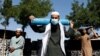 A man waits outside a factory to get his oxygen cylinder refilled on June 15 in Kabul, which like other Afghan cities is facing critical shortages of oxygen and other medical supplies.