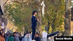 Vida Movahed stands on a utility box to remove her head scarf in protest on December 27, 2017, a move soon repeated by other women in Iran.
