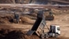 Workers extract the rare earth mineral ilmenite from an open pit mine in Ukraine's central Kirovohrad region.