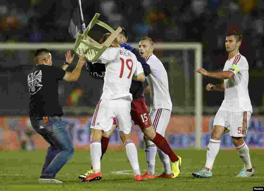 ...with some team officials and fans breaking through security and managing to approach and attack Albanian players.