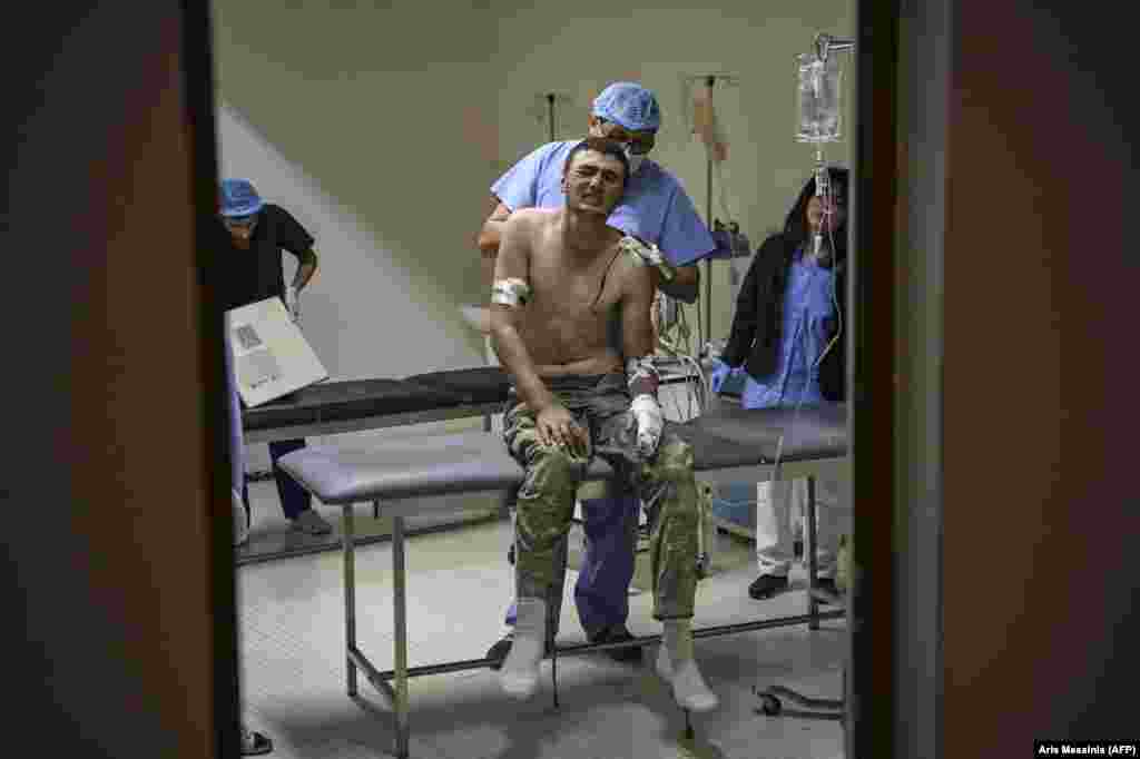 A wounded soldier grimaces in pain as he receives medical care in a hospital outside Stepanakert on October 14.  