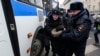 Police detain a protester during a rally near the Russian Defense Ministry headquarters in Moscow.