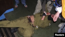 Pro-Palestinian activists hold down an Israeli commando on the Gaza-bound Turkish ship "Mavi Marmara." Nine Turkish nationals were killed when Israeli forces boarded the ship in international waters in 2010.