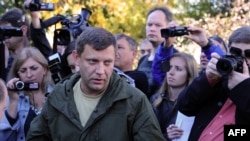 Ukrainian separatist leader Aleksandr Zakharchenko, speaks to journalists in the Donbas. Many reporters who have worked in separatist-controlled territory in eastern Ukraine say that liaising with the de facto authorities there is necessary for them to be able to carry out their jobs.