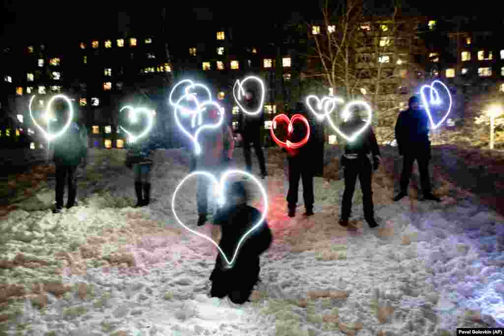 People draw hearts with their cell-phone flashlights in support of jailed opposition leader Aleksei Navalny and his wife, Yulia Navalnaya, in Moscow on the night of February 14. Navalny's team urged people to stand in their courtyards and shine their cell-phone flashlights under the slogan, "Love is stronger than fear." After the jailing of Navalny and two weekends of nationwide demonstrations and marches, the new protest format looked to some like a retreat.