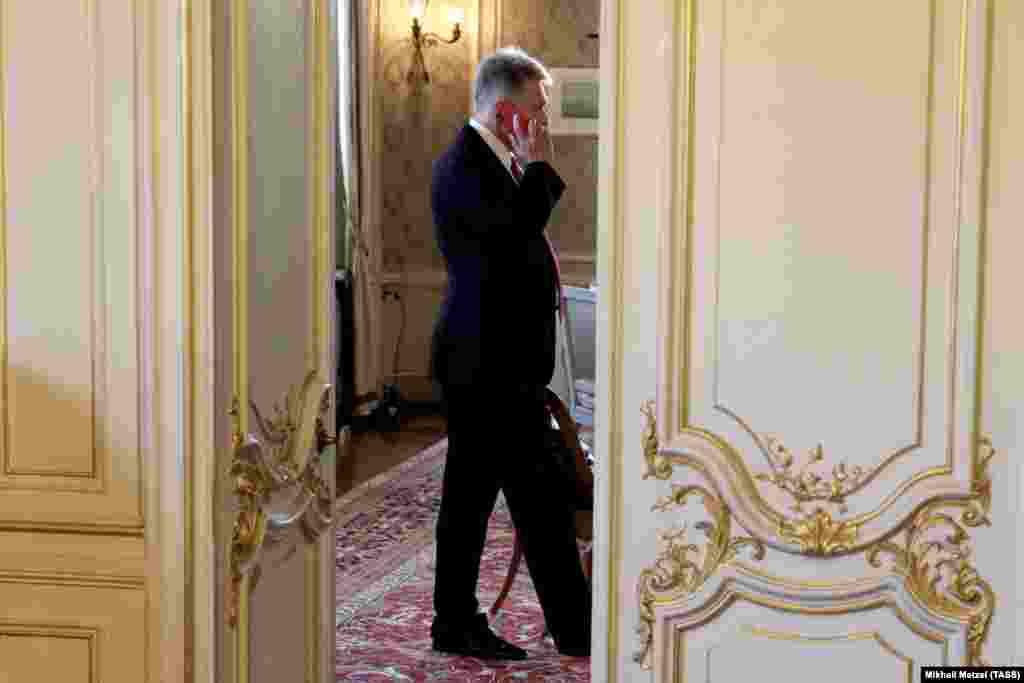 Kremlin spokesman Dmitry Peskov speaks on the phone inside the Villa La Grange. 