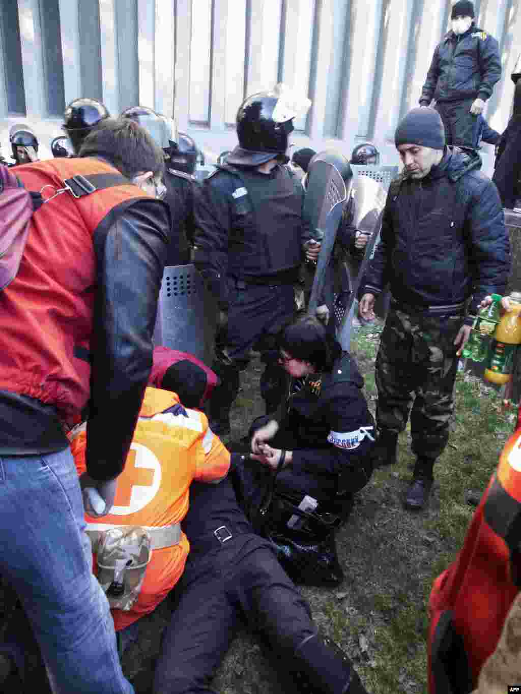 A wounded policeman receives medical assistance following clashes with pro-Russian activists who stormed the SBU building in Lugansk. 