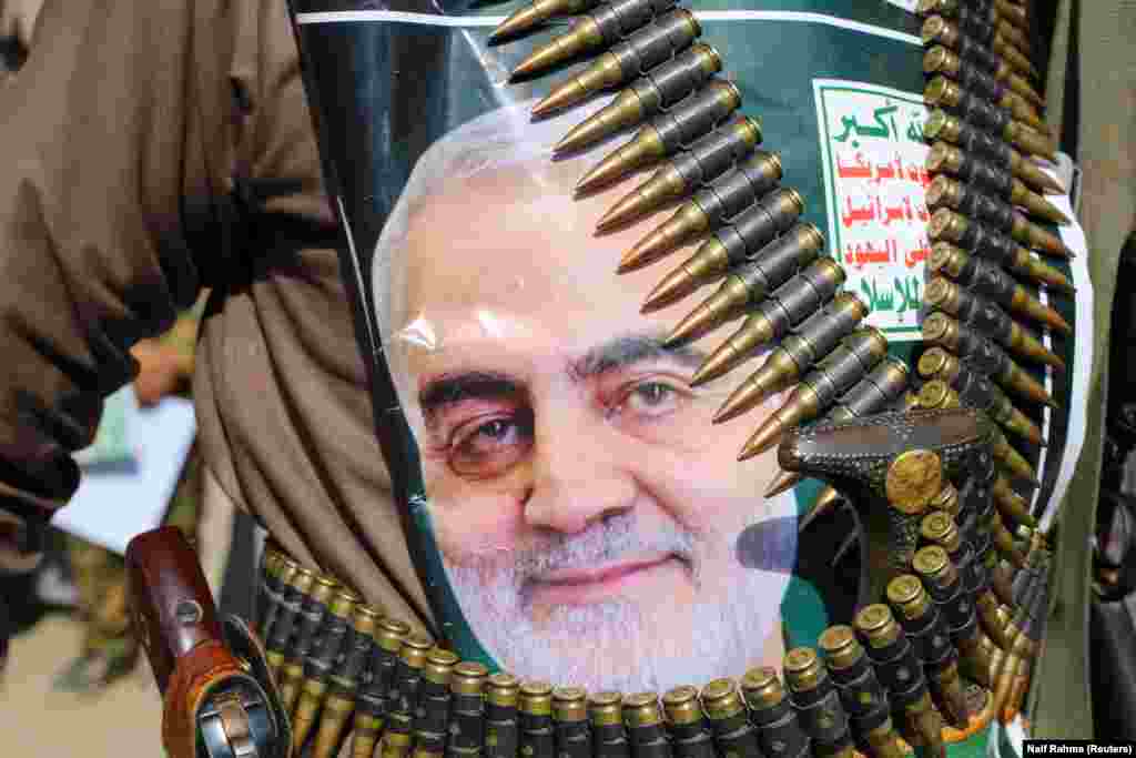 A supporter of the Huthi rebels in Saada, Yemen attached a picture of Soleimani to his clothing. The Iran-backed rebels have called for "swift reprisals" for the killing of the Quds Force commander.