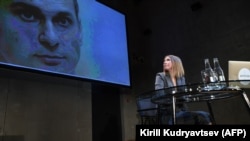 Ksenia Sobchak looks at a picture of Ukrainian prisoner Oleh Sentsov at her press conference in Moscow on October 24.